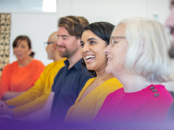 Adults listening to speaker