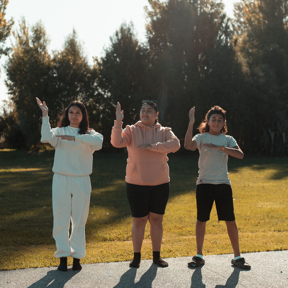 Three tamariki performing