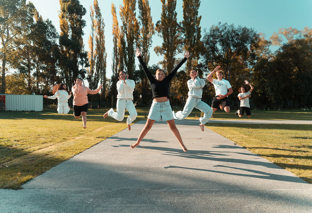 Group of tamariki jumping in the air